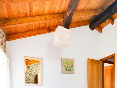 a ceiling light in a room with wooden ceilings at Farmhouse in Castrotañe with Terrace in Castillón