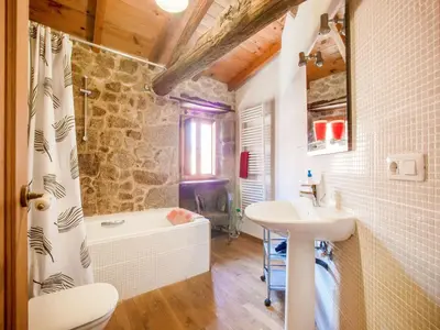 a bathroom with a tub and a sink and a toilet at Farmhouse in Castrotañe with Terrace in Castillón