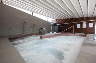 a large hot tub in a building with water at Hotel Thalasso Cantabrico Las Sirenas 4 Superior in Viveiro