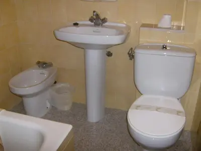 a bathroom with a toilet and a sink at Pensión Monterredondo in Meira