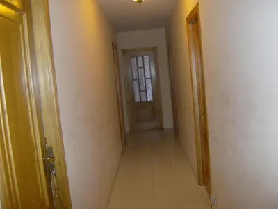 an empty hallway with a door and a window at Pensión Monterredondo in Meira