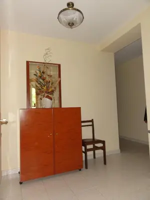 a cabinet in a room with a chair and a mirror at Pensión Monterredondo in Meira