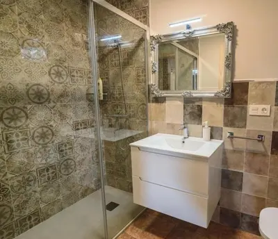 a bathroom with a sink and a shower at Casa Mila in Doade