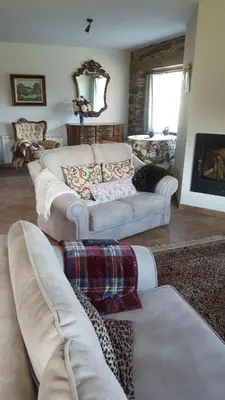 a living room with two couches and a fireplace at Casa Mila in Doade