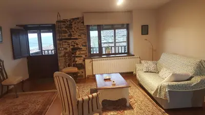 a living room with a couch and a table at Casa Mila in Doade