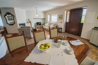 a room with a table with a bowl of fruit on it at Casa Mila in Doade
