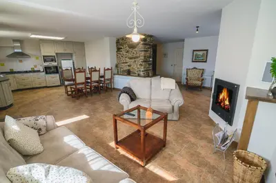 a living room with a couch and a fireplace at Casa Mila in Doade