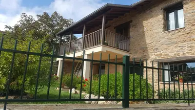 a house with a fence in front of it at Casa Mila in Doade