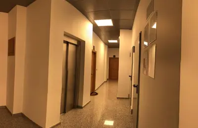 a hallway with white walls and doors in a building at Apartamentos Augusto in La Cañiza