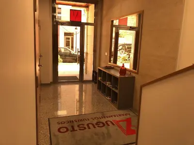 a hallway with a door leading into a building at Apartamentos Augusto in La Cañiza