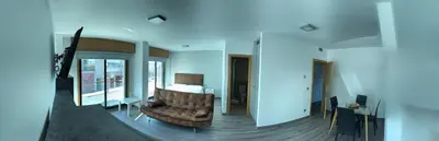 a living room with a leather chair and a table at Apartamentos Augusto in La Cañiza