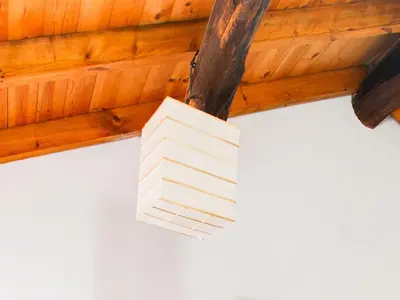 a white light hanging from a wooden ceiling at Traditional Apartment in Ribeira Sacra with Garden in Castillón