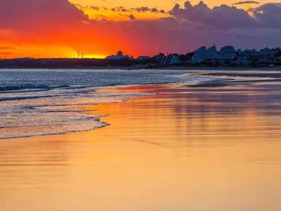a sunset over a beach with the ocean at Traditional Apartment in Ribeira Sacra with Garden in Castillón