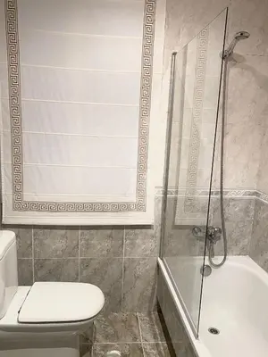 a bathroom with a shower and a toilet and a sink at Pensión Residencia Fornos in Santiago de Compostela