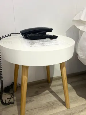 a telephone sitting on top of a white table at Pensión Residencia Fornos in Santiago de Compostela