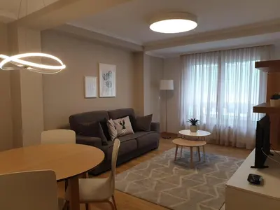 a living room with a couch and a table at APARTAMENTOS PORTA NOVA in Lugo