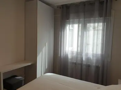 a bedroom with a bed and a window at APARTAMENTOS PORTA NOVA in Lugo