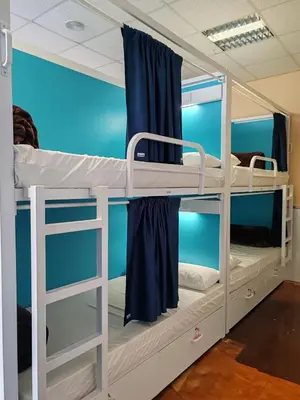 two bunk beds in a room with blue walls at Albergue A Ponte Ribadeo in Ribadeo