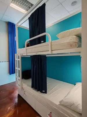 two bunk beds in a room with blue walls at Albergue A Ponte Ribadeo in Ribadeo