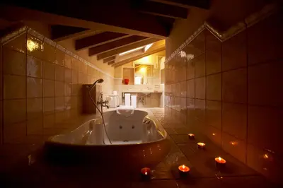 a large bath tub in a bathroom with candles at Areal in Viveiro