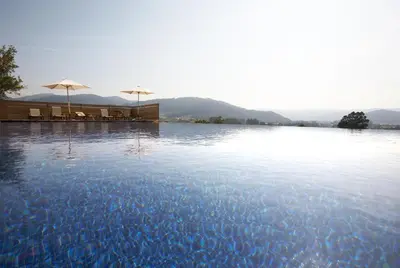 a large pool of water with umbrellas on top of it at Areal in Viveiro