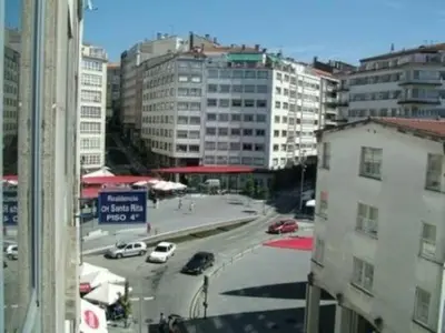a view of a city street with cars and buildings at Pension Santa Rita in Santiago de Compostela