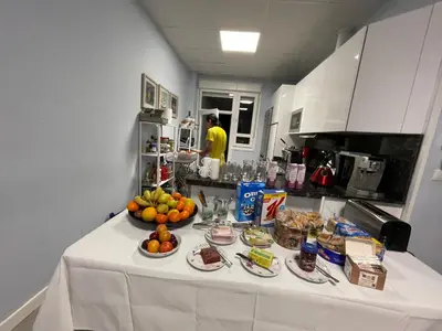 a table with food on it in a kitchen at La Rosa Azul Rooms-Grupo Rosa Azul in Ponferrada