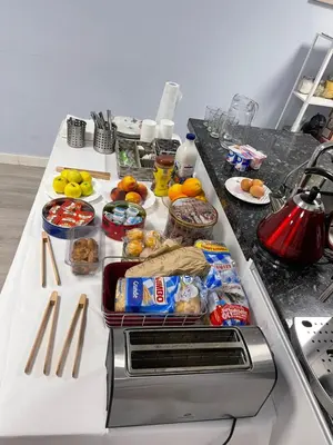 a table with food on it in a kitchen at La Rosa Azul Rooms-Grupo Rosa Azul in Ponferrada