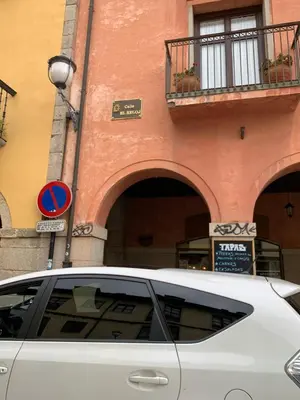 a white car parked in front of a building at La Encina Azul Rooms-Grupo Rosa Azul in Ponferrada