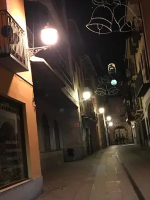 an empty street at night with street lights at La Encina Azul Rooms-Grupo Rosa Azul in Ponferrada