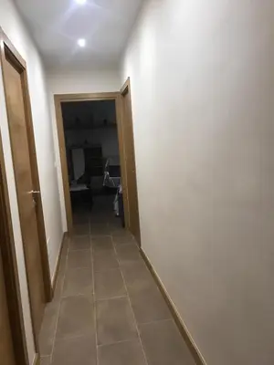 a hallway with a door and a tile floor at La Encina Azul Rooms-Grupo Rosa Azul in Ponferrada