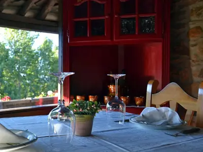 a table with two wine glasses and a plant on it at O Palleiro do Pe do Forno in Orellán