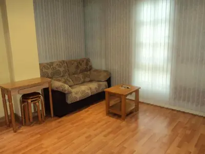 a living room with a couch and a table at Apartamentos Casa Rosendo in Cangas del Narcea