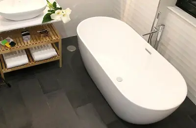 a white toilet in a bathroom with a sink at Apartamentos AUGA in Fene