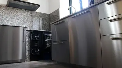 a kitchen with stainless steel appliances in a kitchen at Apartamentos AUGA in Fene