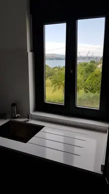 a kitchen with a sink and two windows at Apartamentos AUGA in Fene