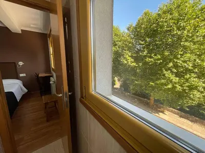 a window in a room with a view of a tree at Hotel San Lázaro in Santiago de Compostela