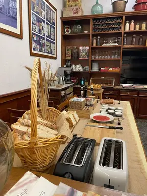 a kitchen with a table with a counter with baskets at Hotel San Lázaro in Santiago de Compostela