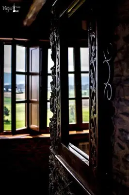 a window with a view of a room with windows at Apartamentos Rurales El Foro in Andés