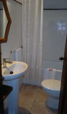 a bathroom with a sink and a toilet and a shower at Apartamentos Rurales El Foro in Andés