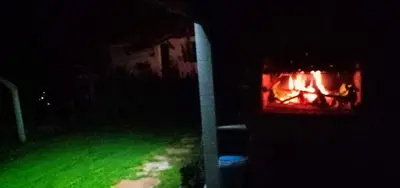 a fire in a fireplace in a yard at night at Casa da Viña - Ribeira Sacra in Nogueira de Ramuin