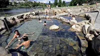a group of people swimming in a hot tub at Casa da Viña - Ribeira Sacra in Nogueira de Ramuin