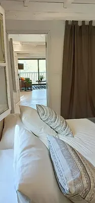 a bedroom with a bed with pillows on it at Casa da Viña - Ribeira Sacra in Nogueira de Ramuin