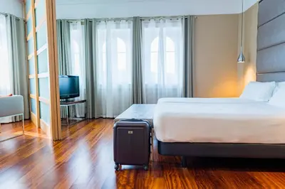 a hotel room with a bed and a television at Hotel Compostela in Santiago de Compostela