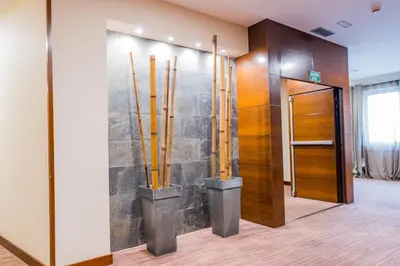 a lobby with a wall with bamboo sticks at Hotel Compostela in Santiago de Compostela