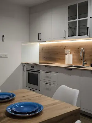 a kitchen with a wooden table with blue plates on it at A casa da Igrexa in Ribadavia