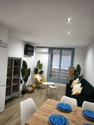 a living room with a table and a couch at A casa da Igrexa in Ribadavia