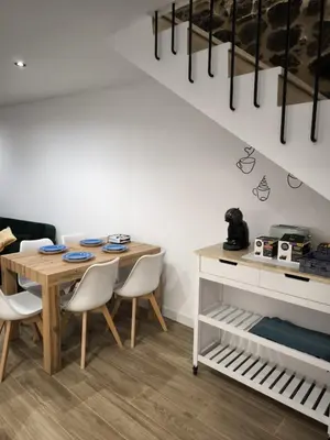 a dining room with a wooden table and chairs at A casa da Igrexa in Ribadavia
