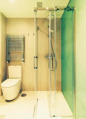 a bathroom with a toilet and a glass shower at Deniké Grupo Atalaia in Santiago de Compostela