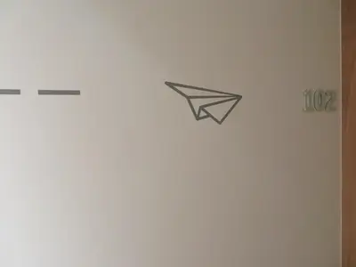 a wall with a paper bird sticker on it at Deniké Grupo Atalaia in Santiago de Compostela